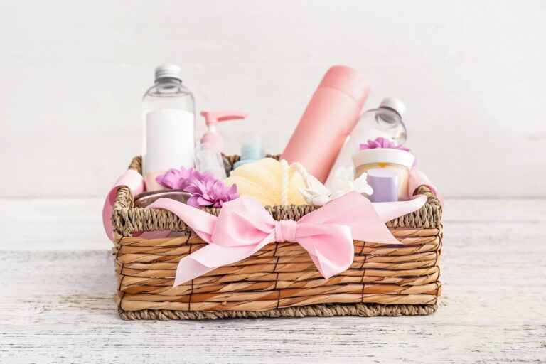 self-care gift basket with pink water bottle and other items in wicker basket.