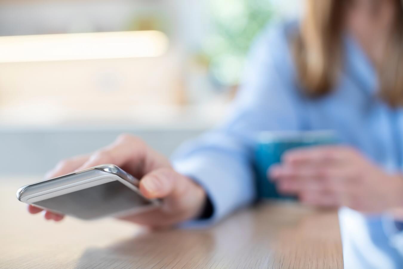 woman putting phone down to have scree-free time.